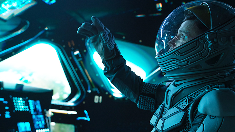 astronaut in shuttle over Earth